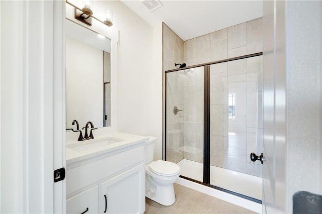 bathroom with vanity, toilet, and an enclosed shower