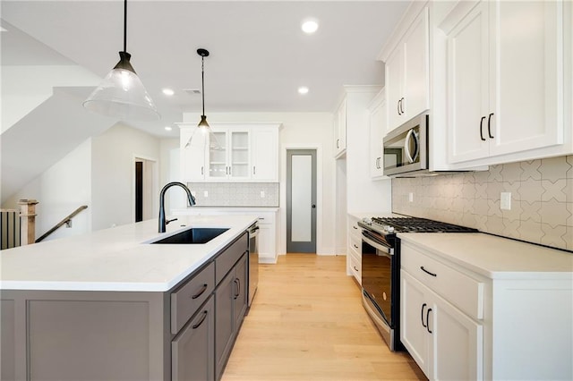 kitchen with sink, decorative light fixtures, appliances with stainless steel finishes, gray cabinets, and white cabinets