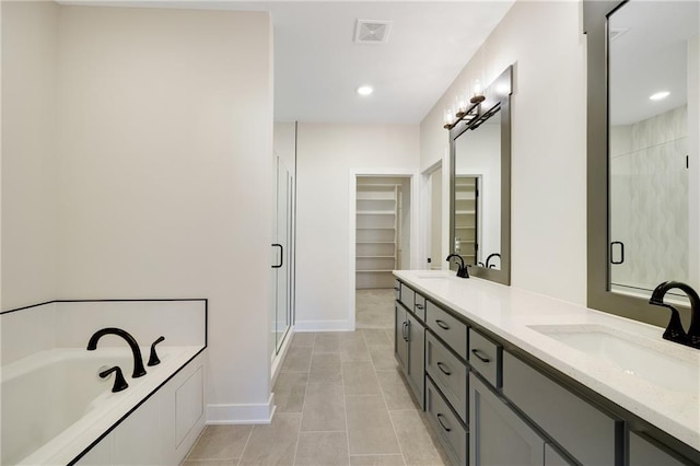 bathroom with vanity, tile patterned flooring, and shower with separate bathtub