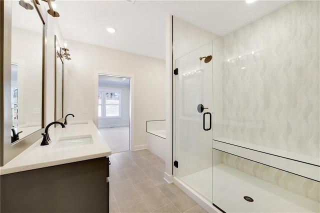 bathroom featuring walk in shower, vanity, and tile patterned flooring