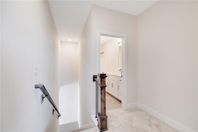 stairway with carpet and sink