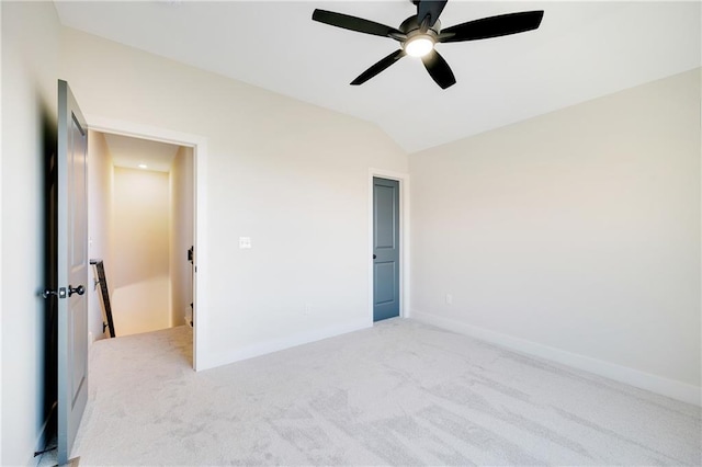 unfurnished bedroom featuring lofted ceiling, light carpet, and ceiling fan