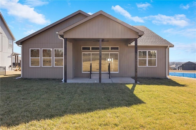 back of house with ceiling fan, a patio, and a lawn