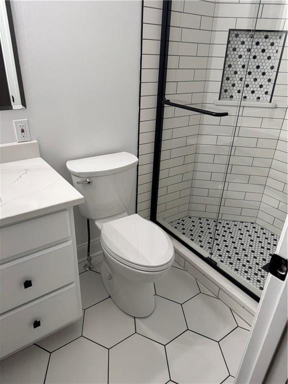 bathroom featuring toilet, vanity, and an enclosed shower