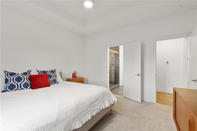 bedroom with light carpet and baseboards