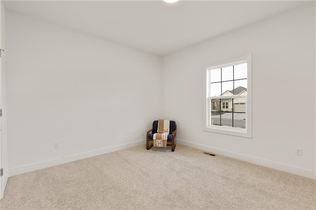 unfurnished room featuring carpet flooring, visible vents, and baseboards