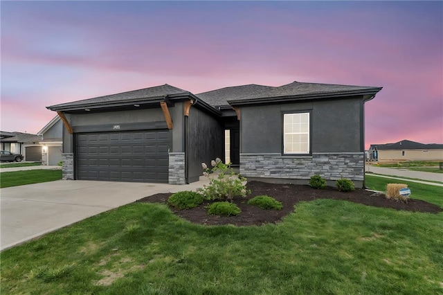 15171 W 173rd St, Olathe, KS 66062 - prairie-style home featuring driveway, stone siding, a garage, a front yard, and stucco siding