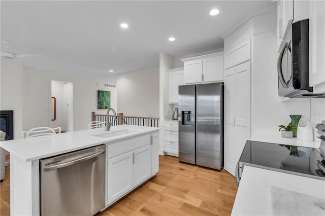 15171 W 173rd St, Olathe, KS 66062 - kitchen featuring a sink, stainless steel appliances, light wood finished floors, light countertops, and white cabinetry