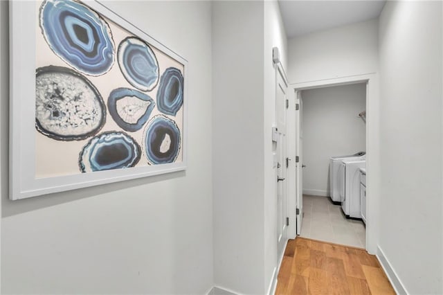 15171 W 173rd St, Olathe, KS 66062 - hallway featuring independent washer and dryer, wood finished floors, and baseboards