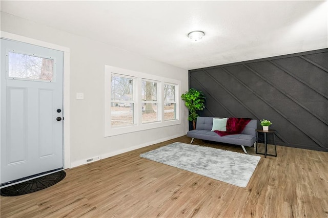 entrance foyer featuring wood walls and hardwood / wood-style floors