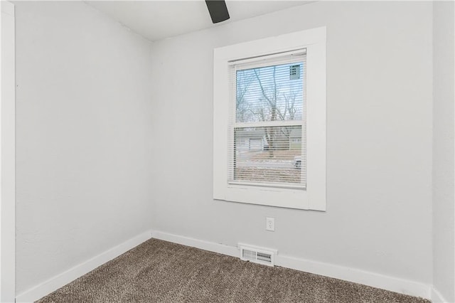 carpeted spare room featuring ceiling fan