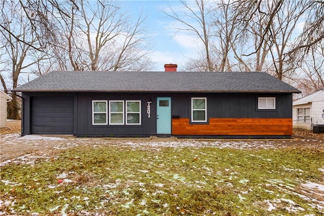 ranch-style house with a garage and a front yard