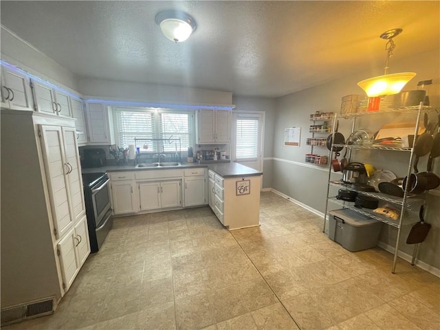 kitchen with pendant lighting, sink, white cabinets, kitchen peninsula, and stainless steel electric range