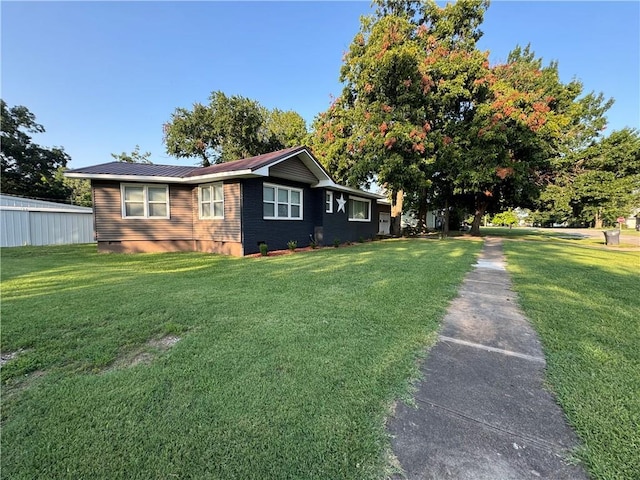 view of side of home with a yard