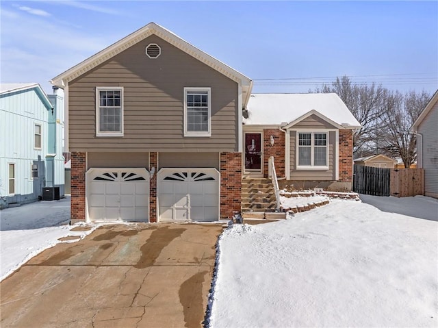 tri-level home with central AC and a garage