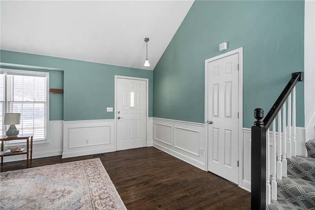 entryway featuring vaulted ceiling and dark wood-type flooring