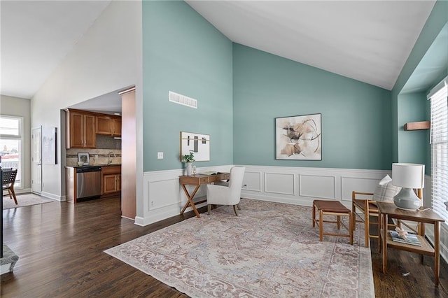 sitting room with dark wood-type flooring, sink, and vaulted ceiling