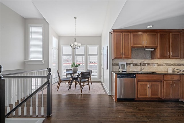 kitchen with dark wood-type flooring, sink, dishwasher, a notable chandelier, and backsplash