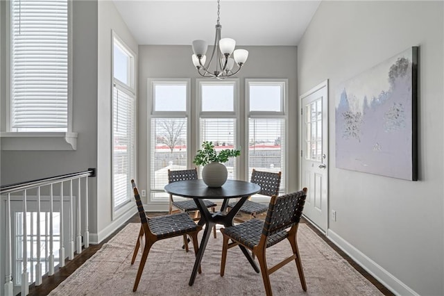 dining room with hardwood / wood-style flooring and a chandelier