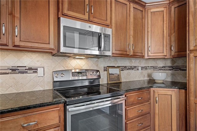 kitchen featuring dark stone countertops, tasteful backsplash, and stainless steel appliances