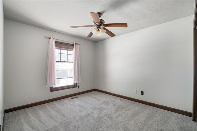 carpeted empty room featuring a textured ceiling and ceiling fan