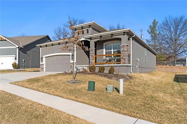 view of front of home with concrete driveway, stone siding, an attached garage, a porch, and a front yard