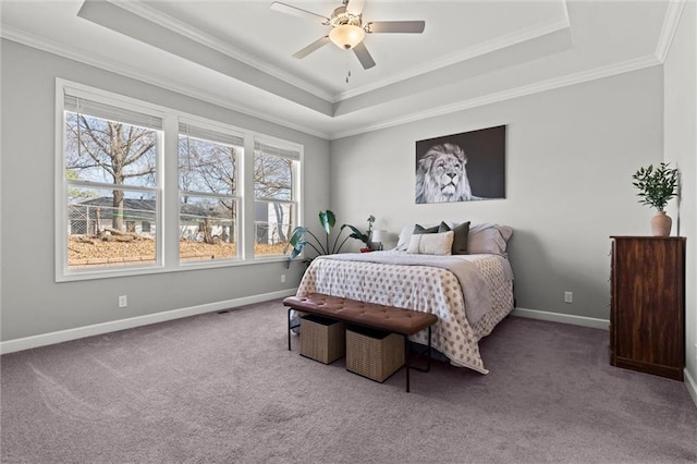 carpeted bedroom featuring a raised ceiling, crown molding, baseboards, and ceiling fan