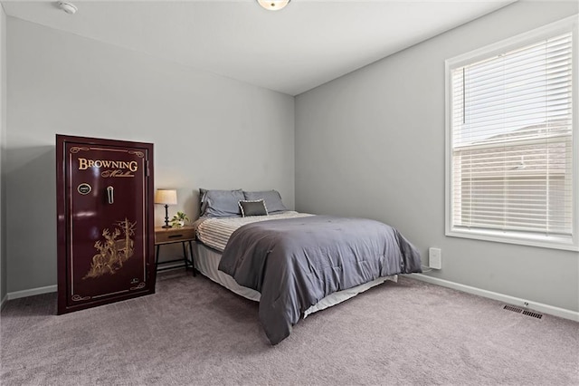 carpeted bedroom with visible vents and baseboards