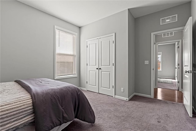 bedroom with multiple windows, carpet, and visible vents