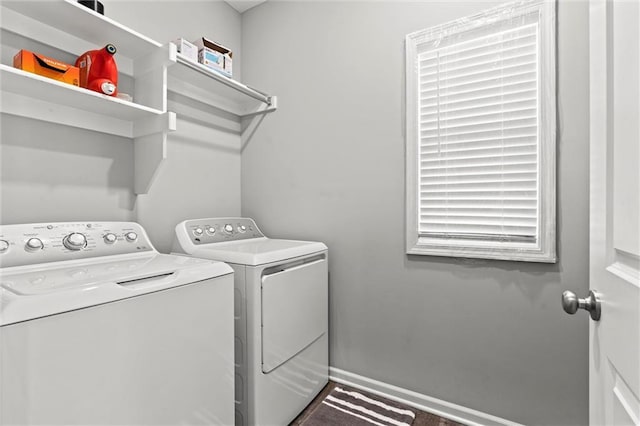 laundry room with laundry area, baseboards, and washer and dryer