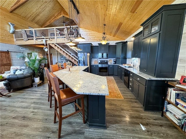 kitchen with appliances with stainless steel finishes, dark wood-style flooring, a sink, and wood ceiling