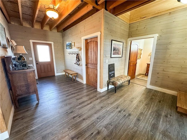 foyer with dark wood-style flooring, beamed ceiling, and wooden walls