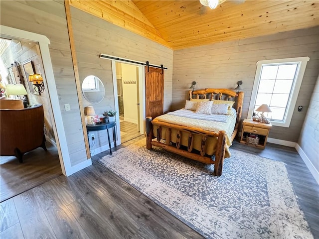 bedroom featuring lofted ceiling, a barn door, wood walls, wood finished floors, and wooden ceiling