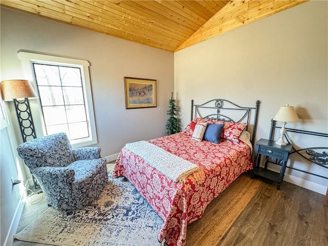 bedroom featuring lofted ceiling, wood ceiling, baseboards, and wood finished floors