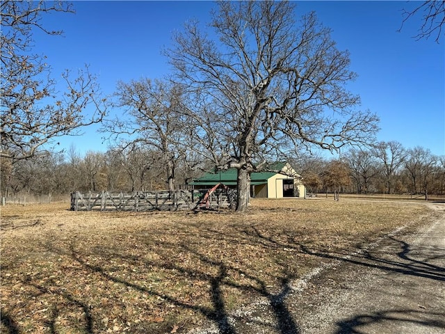 view of yard with a rural view and an outdoor structure