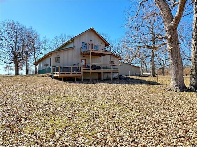 rear view of house with a wooden deck