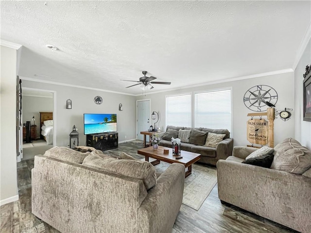 living room featuring a textured ceiling, crown molding, and wood finished floors