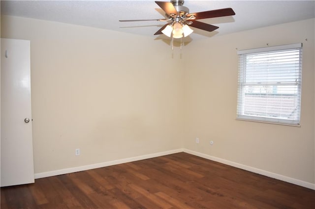 empty room with dark hardwood / wood-style floors and ceiling fan