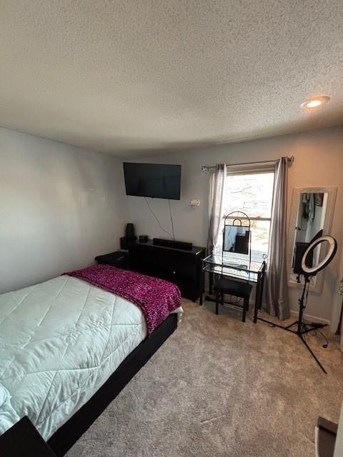 carpeted bedroom featuring a textured ceiling