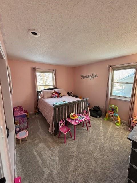 bedroom featuring a textured ceiling and carpet