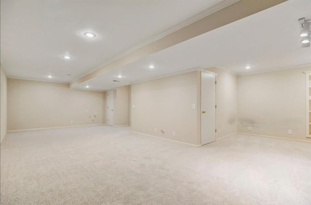 finished basement featuring recessed lighting, baseboards, light colored carpet, and crown molding