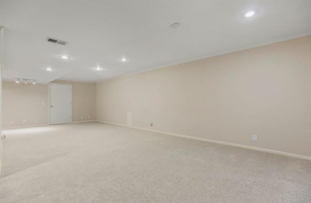 spare room featuring light carpet, visible vents, recessed lighting, and baseboards