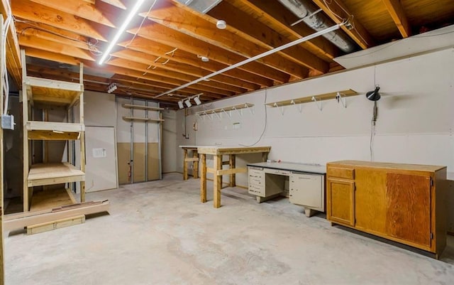 unfinished basement featuring a workshop area