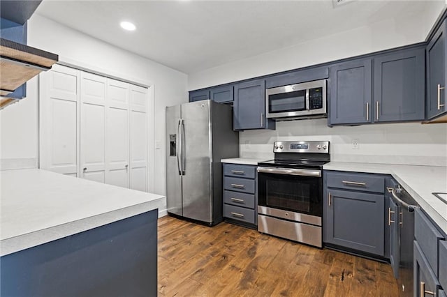 kitchen with dark wood-type flooring and appliances with stainless steel finishes