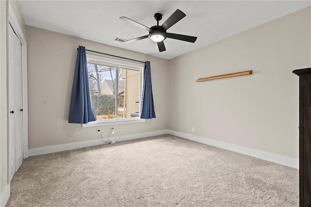 unfurnished bedroom featuring light colored carpet, ceiling fan, and a closet