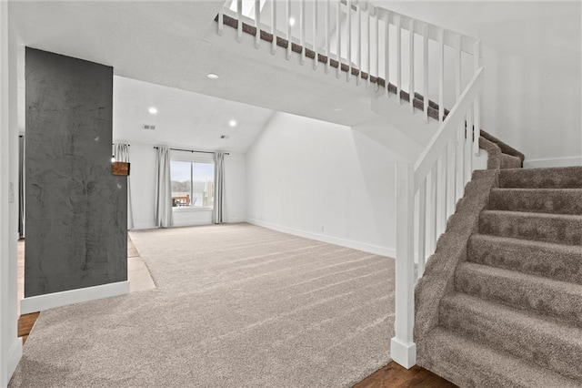 carpeted living area with stairway, recessed lighting, visible vents, and baseboards