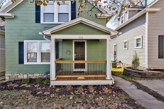 entrance to property with covered porch and central AC unit