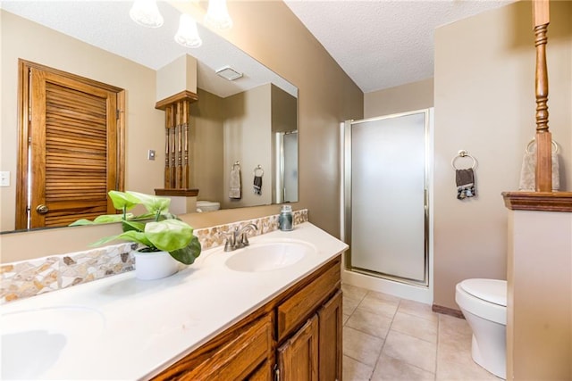 bathroom featuring a shower stall, toilet, and a sink