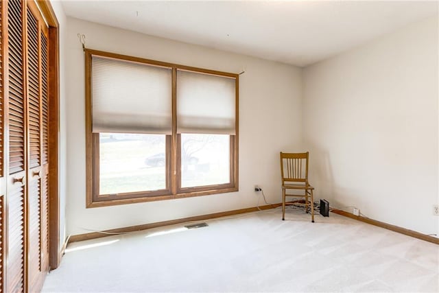 unfurnished bedroom with a closet, carpet floors, baseboards, and visible vents