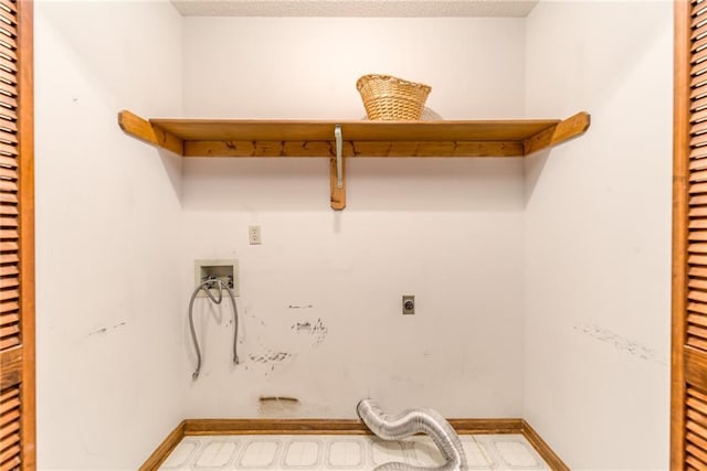 laundry area with hookup for a washing machine, baseboards, laundry area, electric dryer hookup, and a textured ceiling